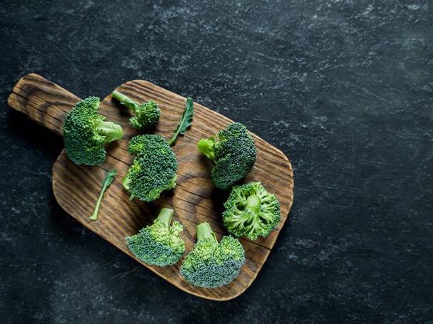 Fresh green broccoli on a black stone table. - Φωτογραφία, εικόνα