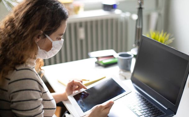 Young woman working from home after coronavirus pandemic - Photo, image