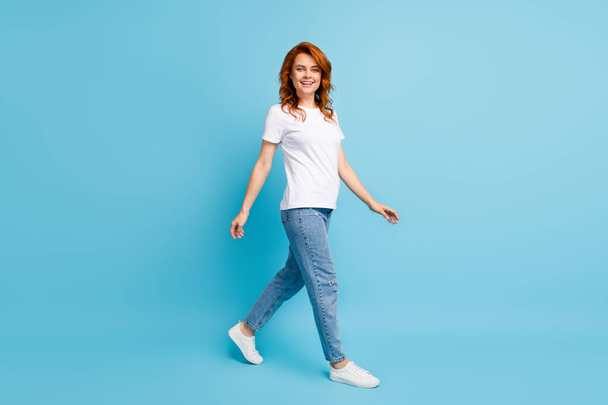 Photo portrait full body view of woman walking isolated on pastel blue colored background - Fotoğraf, Görsel