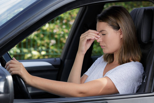 beautiful woman sitting in car suffering from migraines - Photo, Image