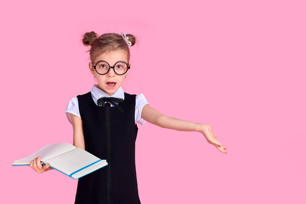 primary school girl in uniform, round glasses without lenses hol - Fotoğraf, Görsel