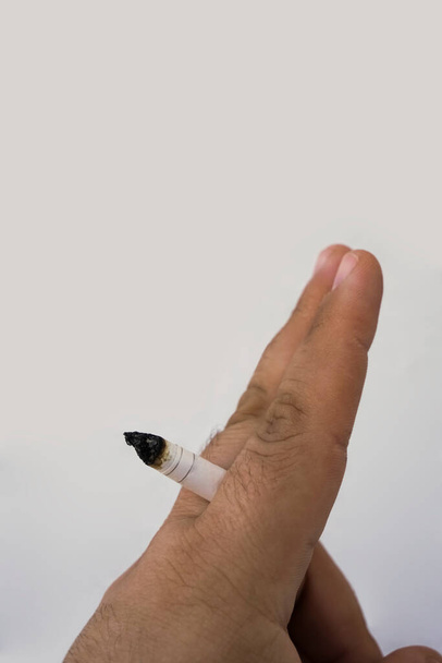 close up man hand with burning cigarette as penis in smoking. Man hand with burning cigarette as penis in smoking cause sexual - Fotó, kép