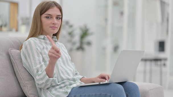 Serious Young Woman with Laptop saying No with Finger  - 写真・画像