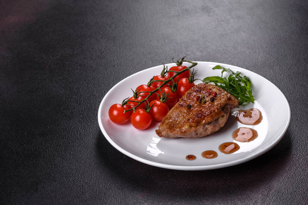 Baked duck breast with herbs and spices on a dark concrete background. Fried meat ready to eat - Valokuva, kuva