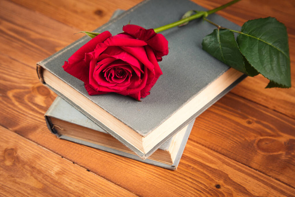 red rose on a book on a wooden background - Photo, Image