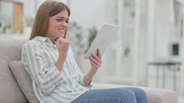 Excited Young Woman Celebrating Success on Tablet  - Valokuva, kuva