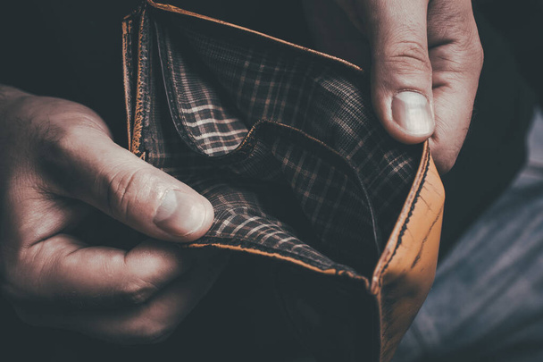 Man Showing His Empty Wallet - No Money Left Concept - Foto, afbeelding