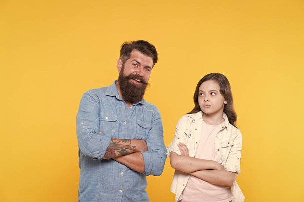 Loving their casual look. Small child and bearded man in casual style. Father and little daughter yellow background. Casual fashion. Casual appeal. Family clothing store. Fashion and style - Fotoğraf, Görsel