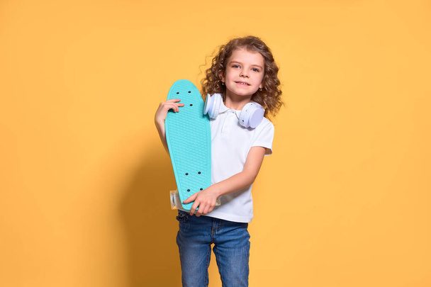 Active and happy Kid having fun with penny board, smiling face s - Foto, Bild