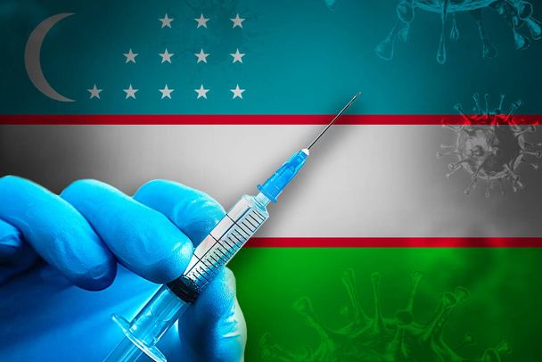 Oezbekistan Covid-19 Vaccinatiecampagne. Een hand in een blauwe rubberen handschoen houdt een spuit met covid-19 virusvaccin voor de Oezbeekse vlag. Concept voor vaccinatie tegen coronavirus - Foto, afbeelding
