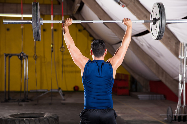 Strong man lifting weights - Photo, Image