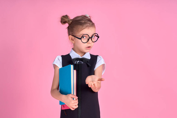 primary school girl in uniform, round glasses without lenses hol - Φωτογραφία, εικόνα