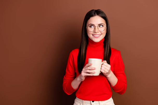 Photo of nice optiimstic brunette lady look empty space wear spectacles sweater isolated on brown background - Fotoğraf, Görsel