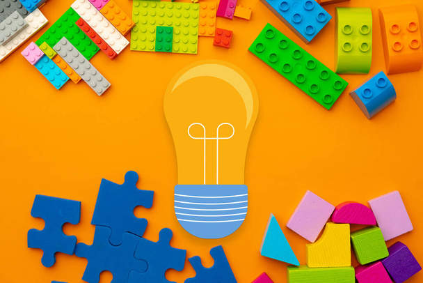 Ideas concept with light bulb and toy constructor details - Φωτογραφία, εικόνα