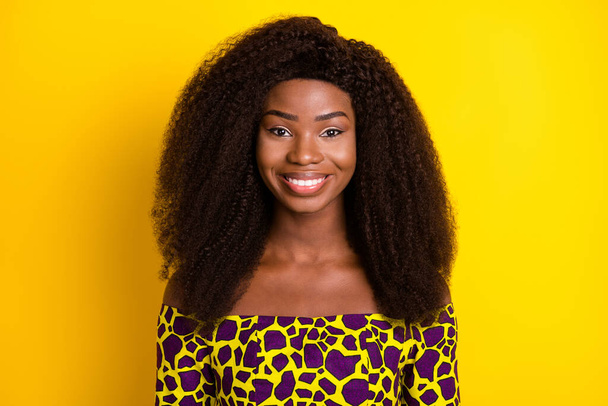 Portrait of gorgeous cheerful wavy-haired girl wearing vivid blouse isolated over bright yellow color background - Fotoğraf, Görsel