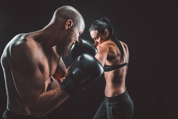 Shirtless Woman exercising with trainer at boxing and self defen - Foto, Imagen