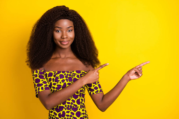 Portrait of attractive confident girl demonstrating copy empty space ad look idea isolated over bright yellow color background - Fotoğraf, Görsel