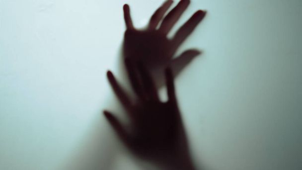 Macro video of hands shadow moving in air in studio. Beautiful slim fingers . - Photo, Image