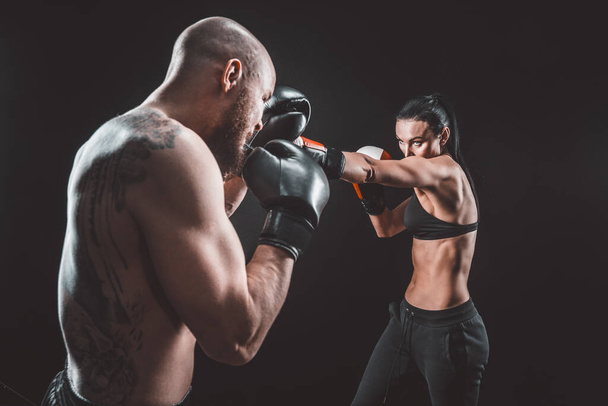 Shirtless Woman exercising with trainer at boxing and self defen - Foto, Imagen