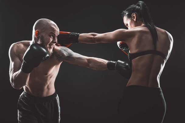 Shirtless Woman exercising with trainer at boxing and self defen - Fotografie, Obrázek