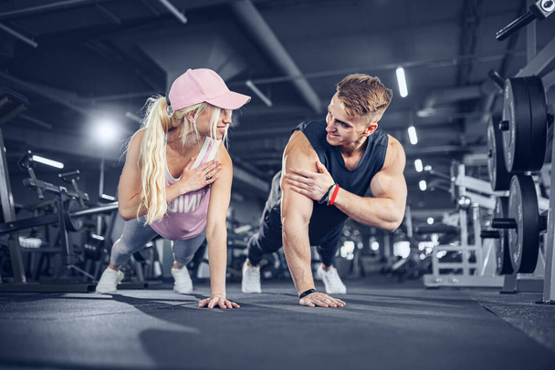 Man and woman strengthen hands at fitness training - Φωτογραφία, εικόνα