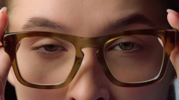 Macro portrait of serious businesswoman wearing glasses for working in office . - 写真・画像