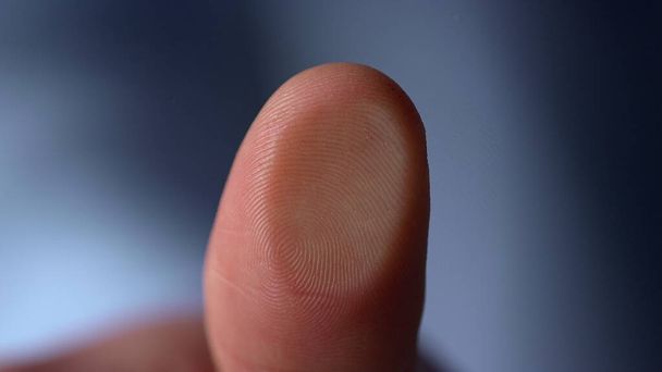 Marco video of fingerprint on glass surface indoors.Man thumprint on windowpane - Фото, изображение