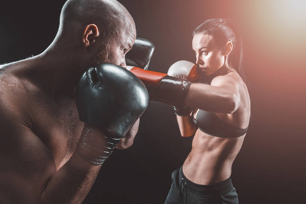 Shirtless Woman exercising with trainer at boxing and self defen - Fotoğraf, Görsel