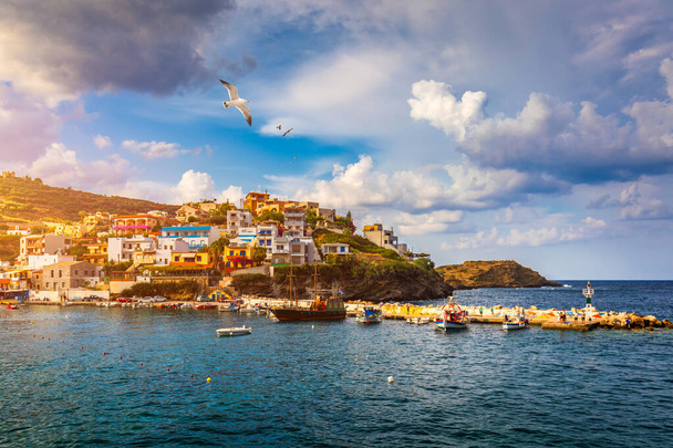 Panorama of Harbour with vessels, boats, beach and lighthouse in Bali at sunrise, Rethymno, Crete, Greece. Famous summer resort in Bali village, near Rethimno, Crete, Greece.  - Photo, Image