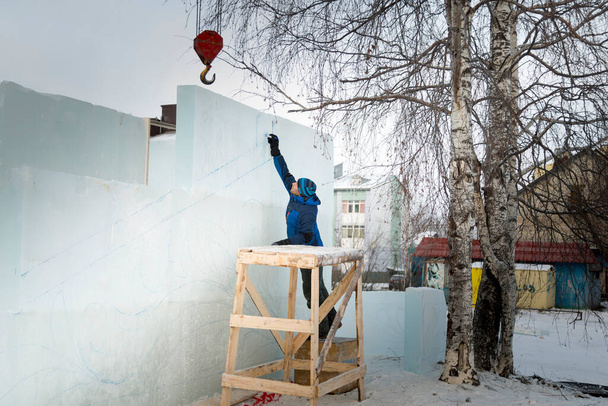 Художник рисует контуры будущей фигуры льда на льду - Фото, изображение