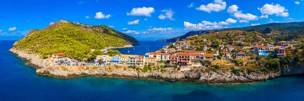 Τυρκουάζ χρωματιστός κόλπος στη Μεσόγειο με όμορφα πολύχρωμα σπίτια στο χωριό Άσσος στην Κεφαλονιά. Πόλη της Άσσου με πολύχρωμα σπίτια στη Μεσόγειο θάλασσα, Ελλάδα.  - Φωτογραφία, εικόνα