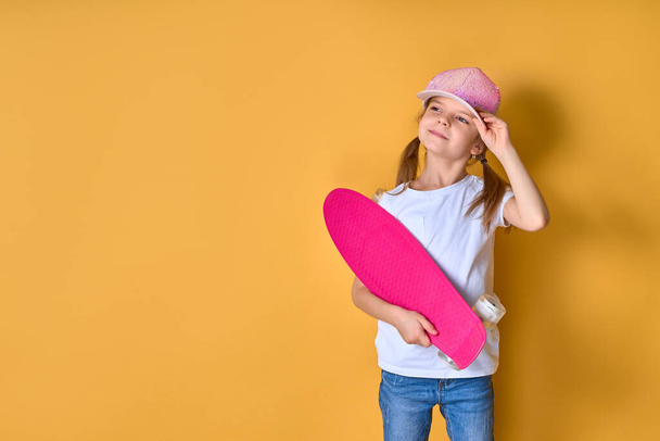 Active and happy. Kid having fun with penny board. Child smiling - Foto, imagen