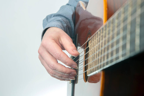 male guitarist hands with nails while playing music. classical guitar - Foto, immagini