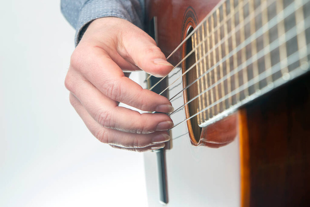 male guitarist hands with nails while playing music. classical guitar - Photo, image