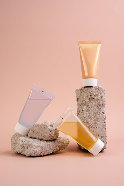 Cream, lotion and cleansing gel. Facial care cosmetics on a beige background. Cosmetics for skin health. Serums with vitamin C. Unisex cosmetics. Mockup. - Foto, Imagem