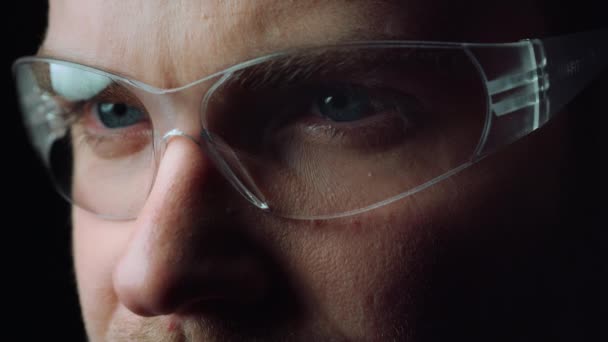 Close up of face of focused man opening beautiful blue eyes with glasses.  - Footage, Video