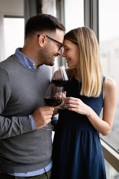 Happy couple in love drinking wine and having romantic date - Foto, Imagem