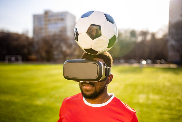 happy man in virtual reality glasses in football field background is blurred concept of virtual reality outdoors summer sunny day - Photo, Image