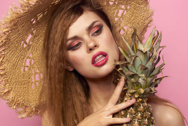woman in beach hat pineapple exotic swimsuit pink background - Φωτογραφία, εικόνα