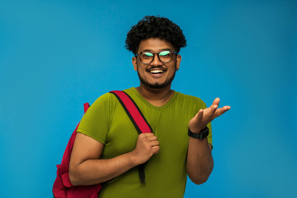 Indian smiling student isolated on blue background, studio photo. - Foto, imagen