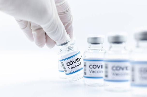 Vaccine concept in the hand of doctor white vaccine jar with copy space. Vaccine Concept of the fight against coronavirus, immunization, and treatment, medical concep - Фото, изображение