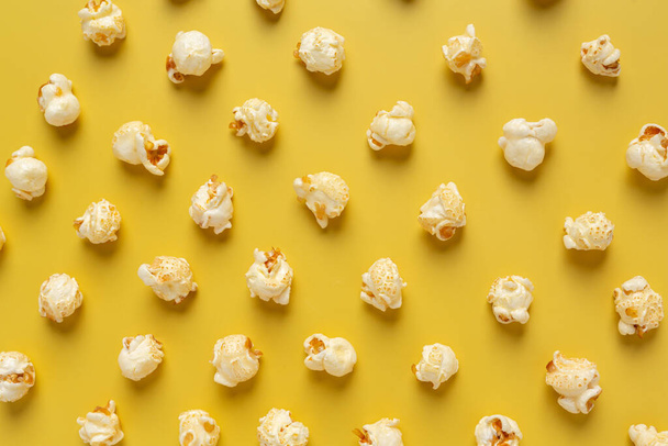 Sweet popcorn on yellow background - Fotó, kép