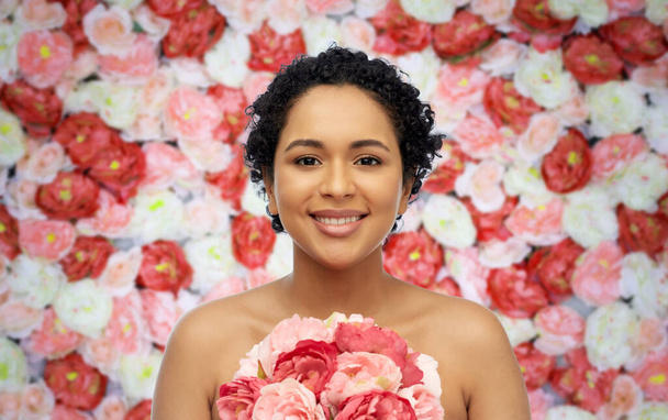 portrait of african american woman with flowers - 写真・画像