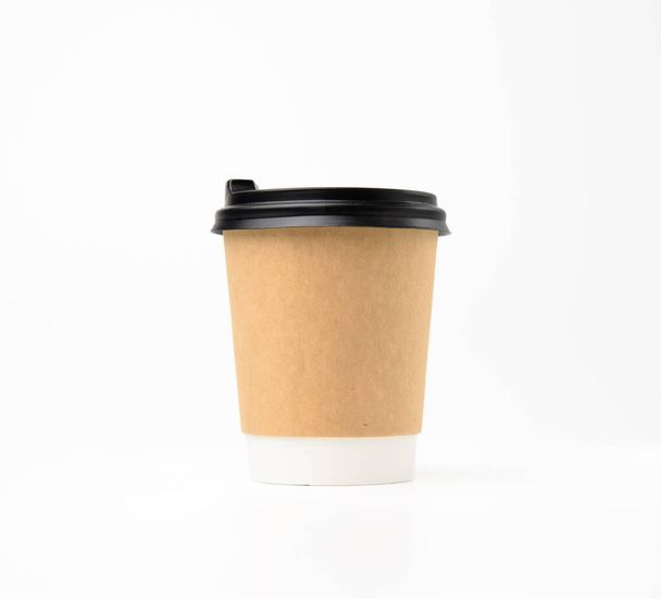 brown paper cup with plastic lid on white background, takeaway beverage container - Photo, image