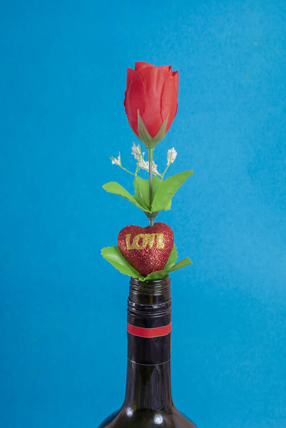 A closeup shot of a colorful artificial bouquet in a flowerpot on blue background - Zdjęcie, obraz