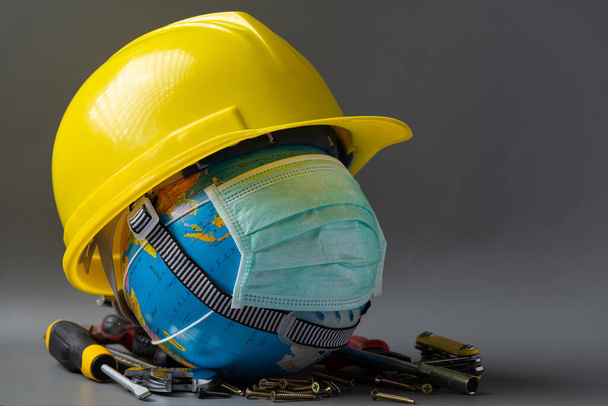 Earth wearing  yellow hard hat,Labor day background  - Photo, image