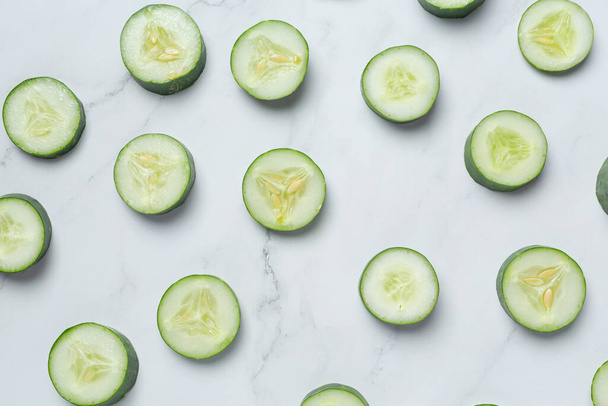fresh cucumbers sliced on marble background - Foto, imagen