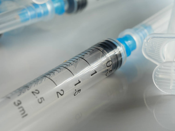 Several syringe on white table prepared for injection in hospital, selective focus, DOF, macro - Photo, Image