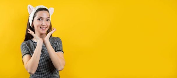 Young girl with ears, on a yellow background. - Foto, Imagem
