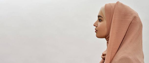 Profile of young arabian girl in traditional hijab - 写真・画像
